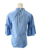 Light blue blouse with ruffled sleeves on a mannequin against a white background