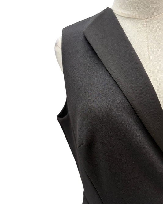 Black dress on a mannequin against a white background