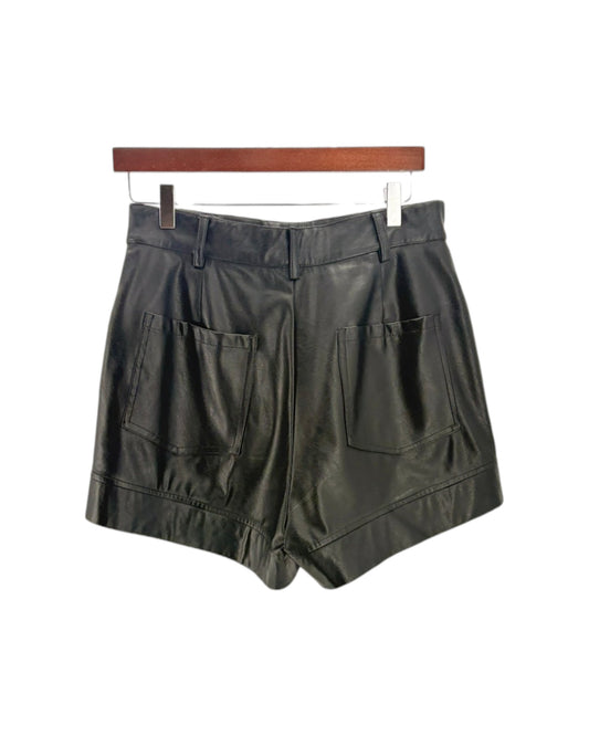Black shorts on a hanger against a white background