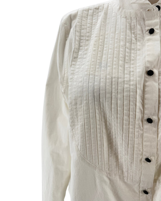 Close-up of a white textured shirt with black buttons on a white background