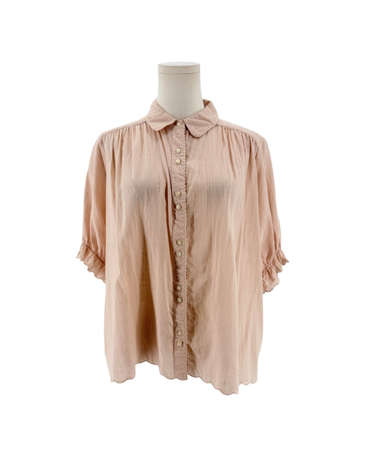 Short sleeve light pink button down top with ruffle details on a mannequin on a white background