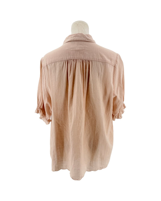 Short sleeve light pink button down top with ruffle details on a mannequin on a white background