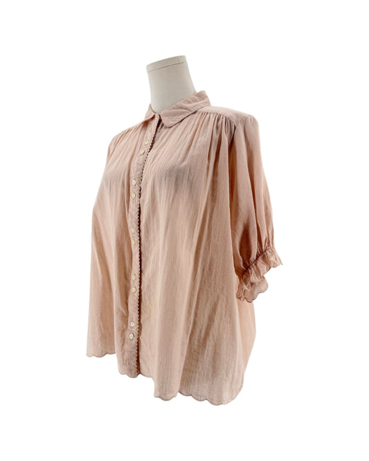Short sleeve light pink button down top with ruffle details on a mannequin on a white background