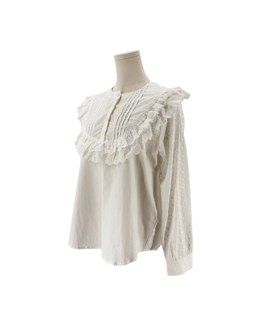 White long sleeve blouse with lace and ruffle details on a mannequin and on a white background