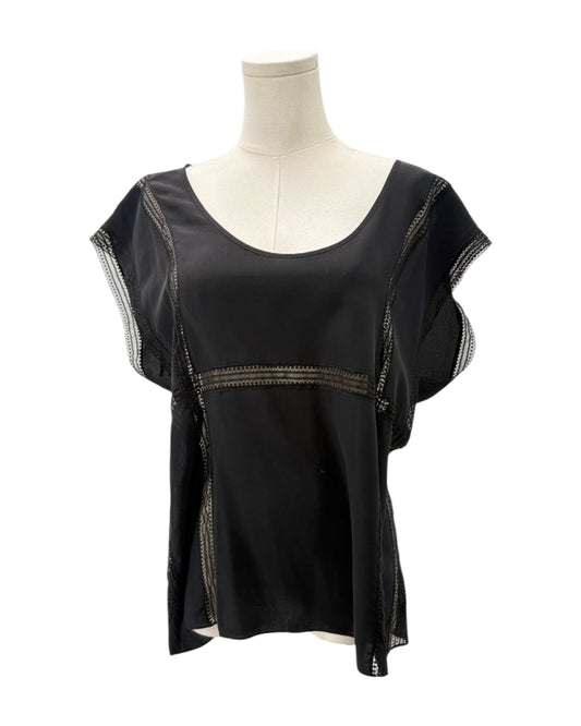 Black top with sheer sleeves on a mannequin against a white background