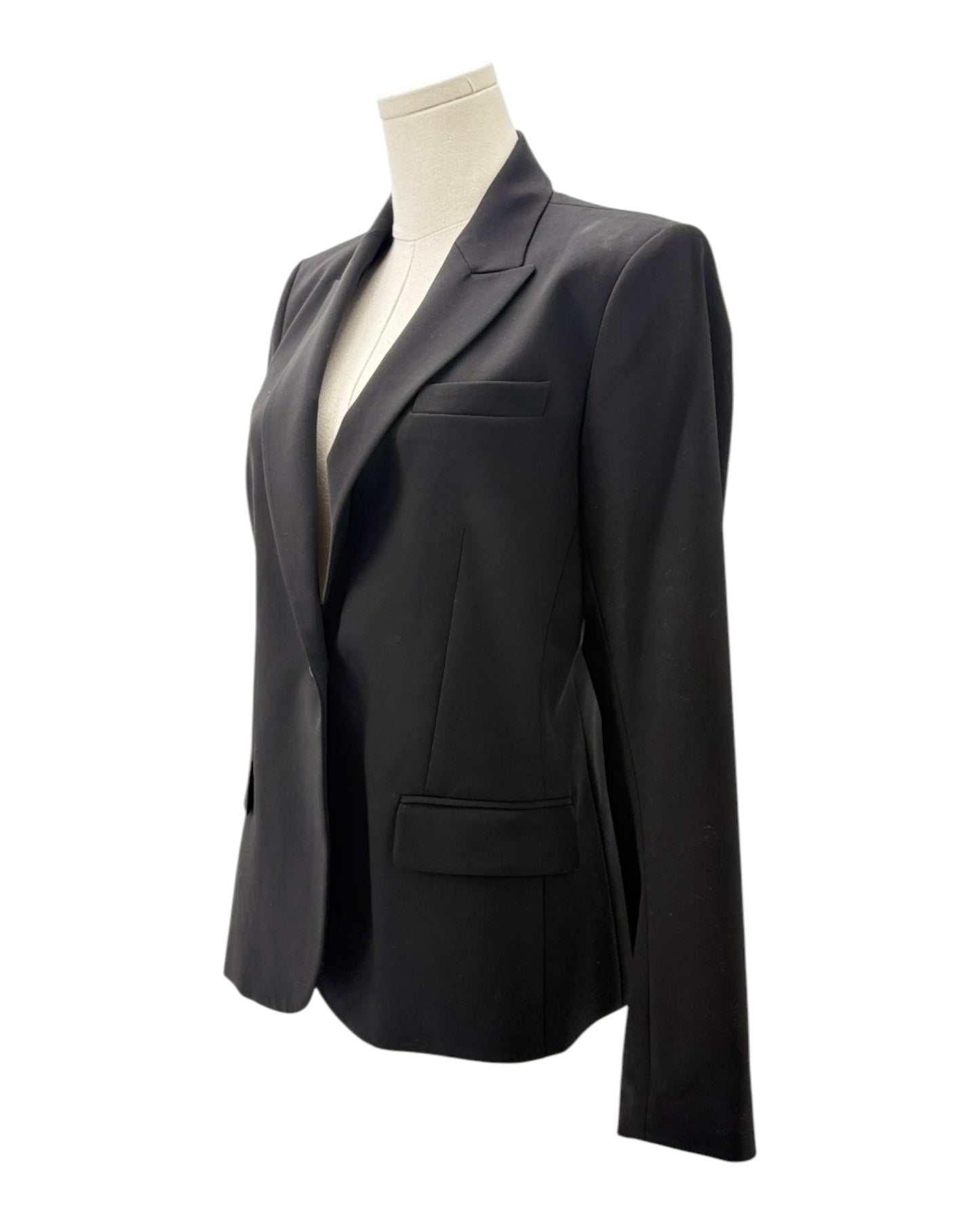 Black blazer on a mannequin against a white background