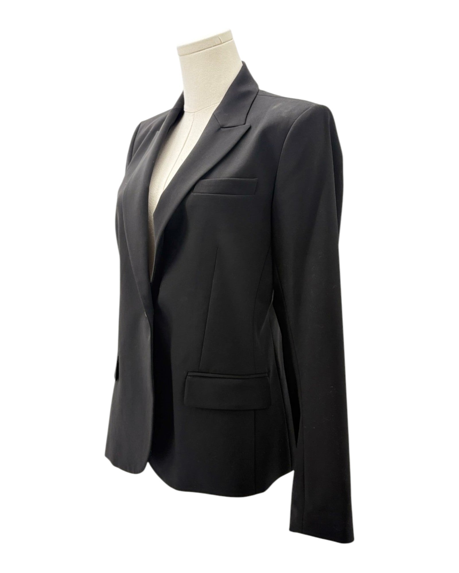 Black blazer on a mannequin against a white background