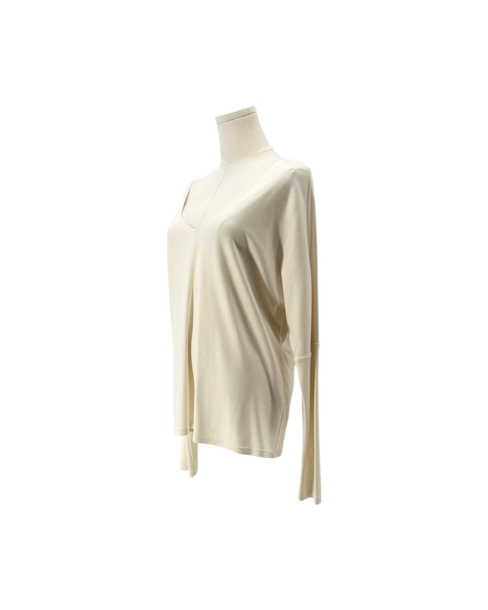 A cream-colored long-sleeve knit top displayed on a mannequin torso against a plain white background.