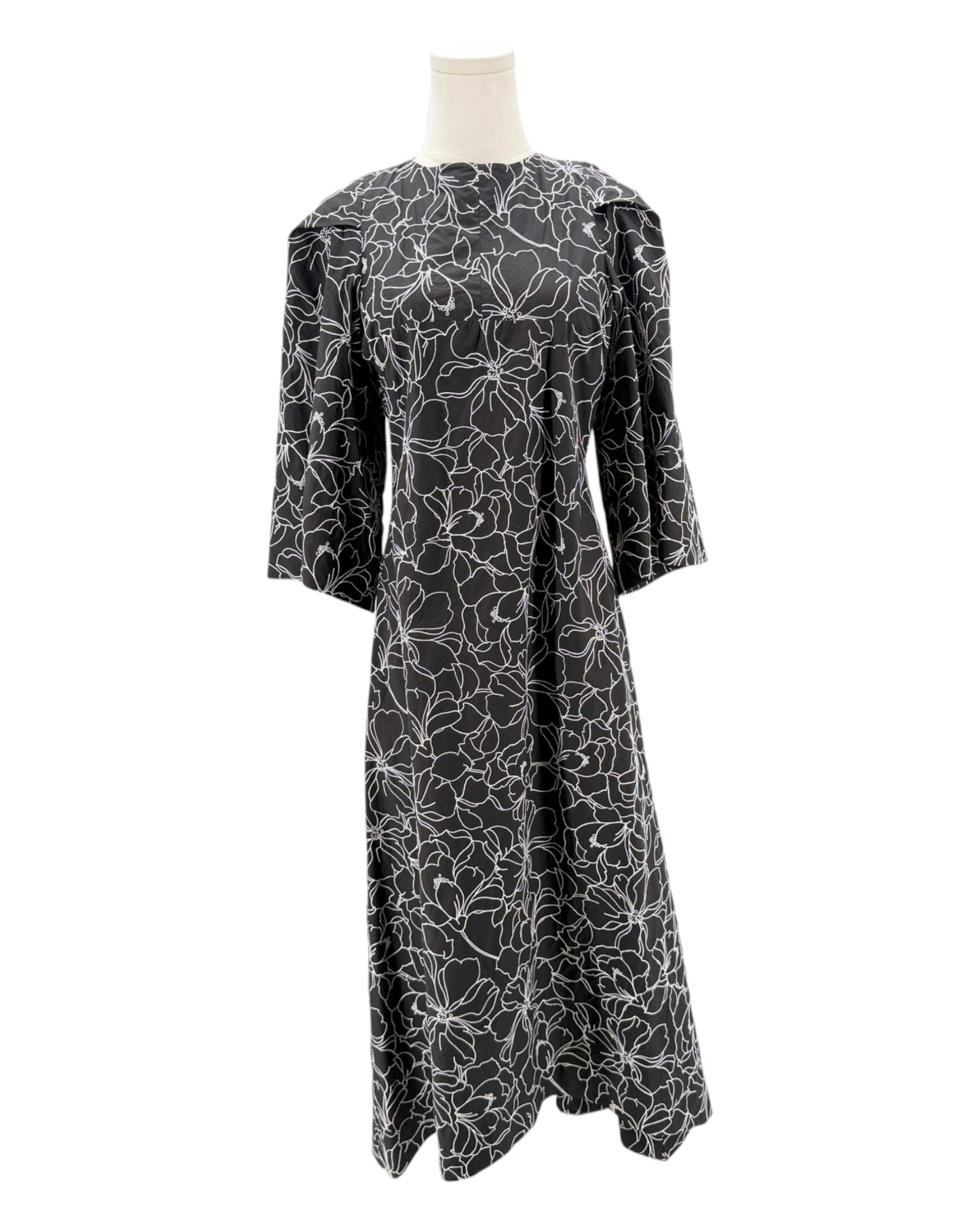 Black floral patterned dress on a mannequin against a white background