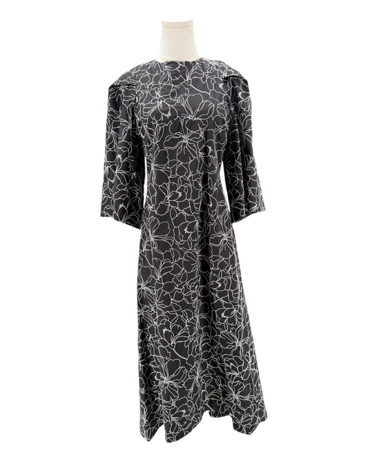 Black floral patterned dress on a mannequin against a white background