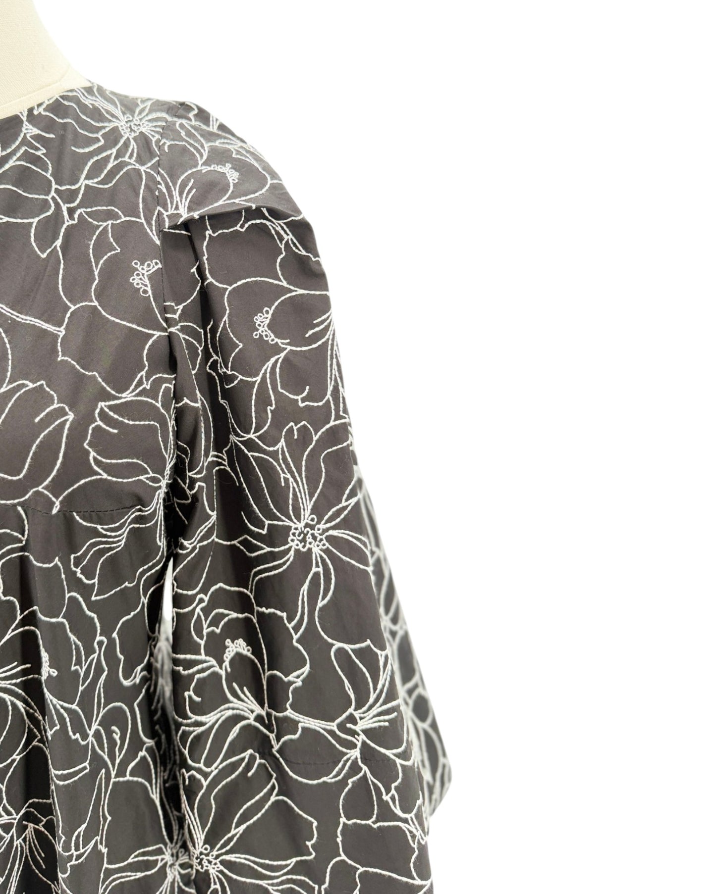 Floral patterned shirt on a mannequin with a white background