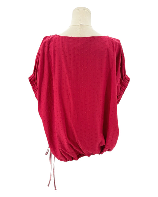 Red top on a mannequin with a white background