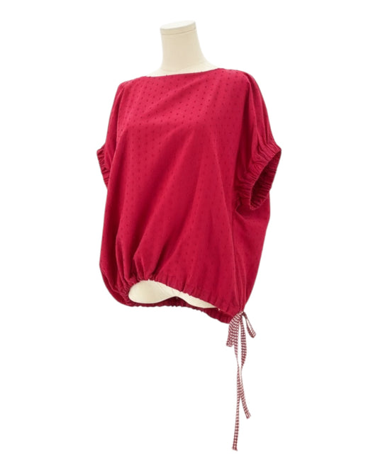 Red top on a mannequin with a white background