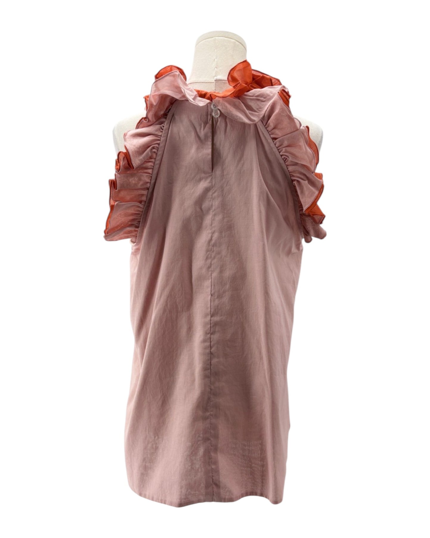 Mannequin wearing a pink top with orange ruffled accents on a white background