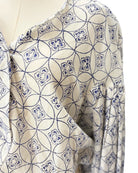 Mannequin wearing a patterned blouse with blue and white design