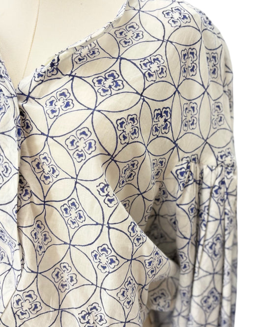 Mannequin wearing a patterned blouse with blue and white design
