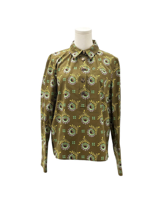 A long-sleeve button-up shirt with an all-over circular floral pattern in olive green, yellow, and white, displayed on a mannequin torso against a plain white background.