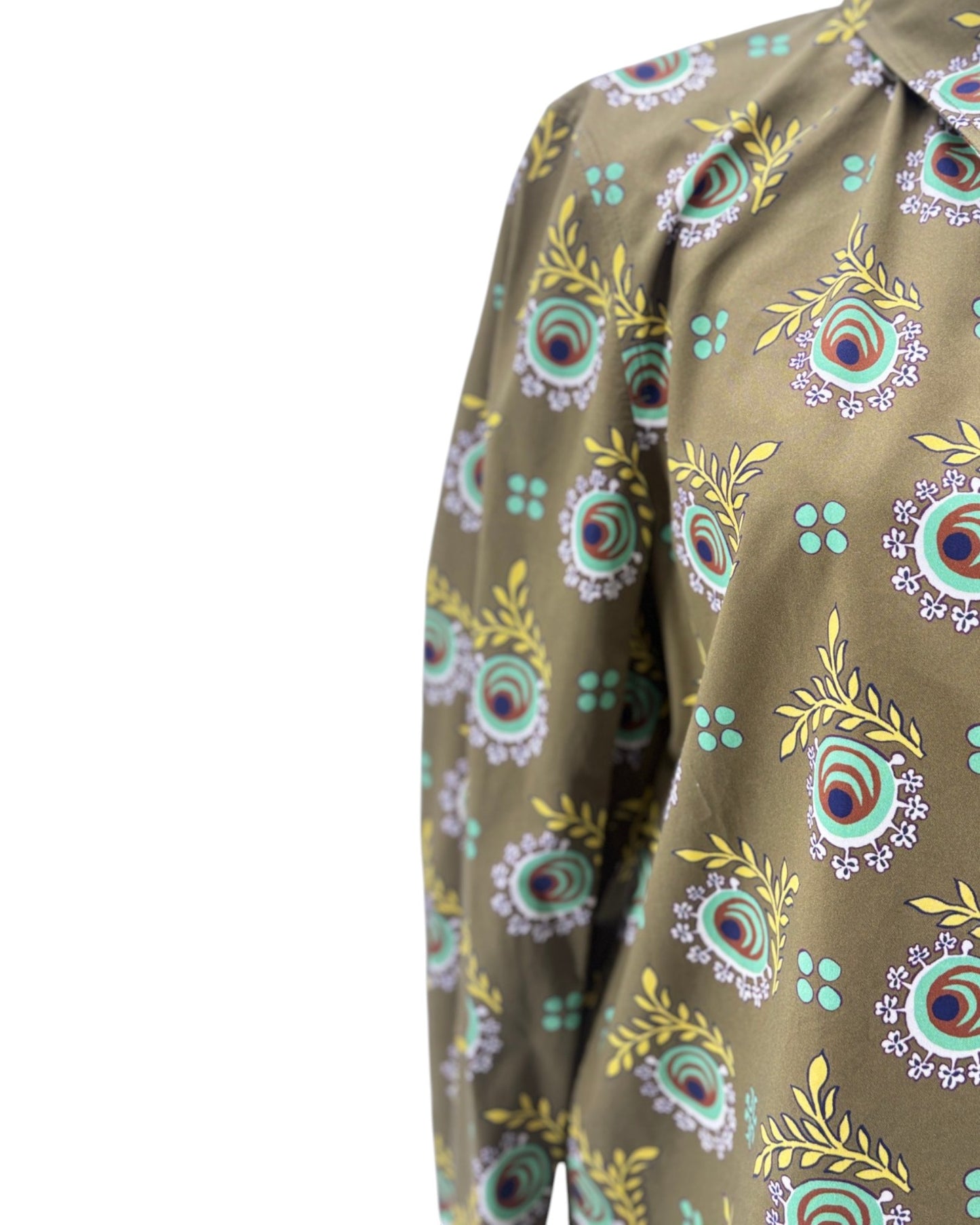 A close-up of a long-sleeve button-up shirt featuring a brown base with a colorful peacock feather and floral block-print pattern in teal, purple, yellow, and red.