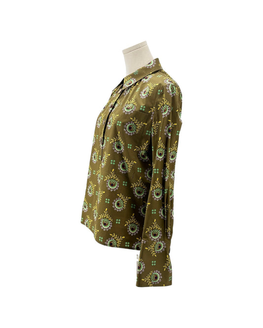 A long-sleeve button-up shirt with an all-over circular floral mandala pattern in olive green, yellow, and light blue, displayed on a mannequin torso against a white background.