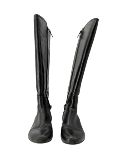 Pair of black knee-high boots on a white background