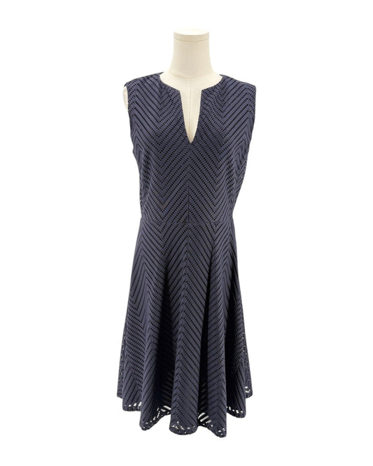 Navy patterned dress on a mannequin against a white background