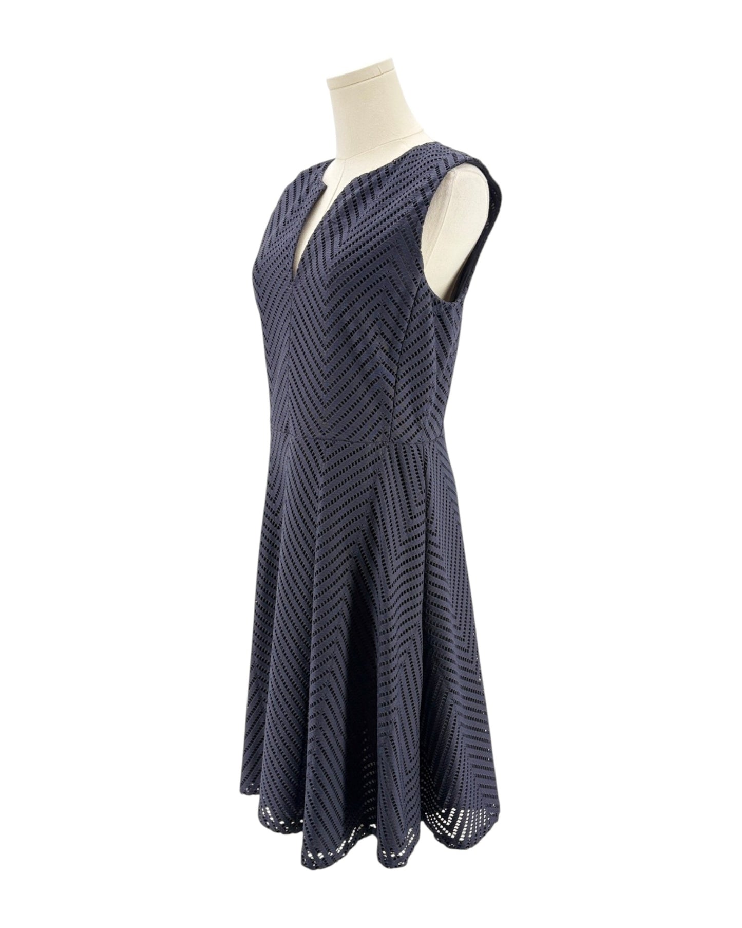Navy patterned dress on a mannequin against a white background