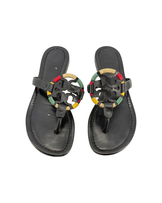Black sandals with colorful embellishments on a white background