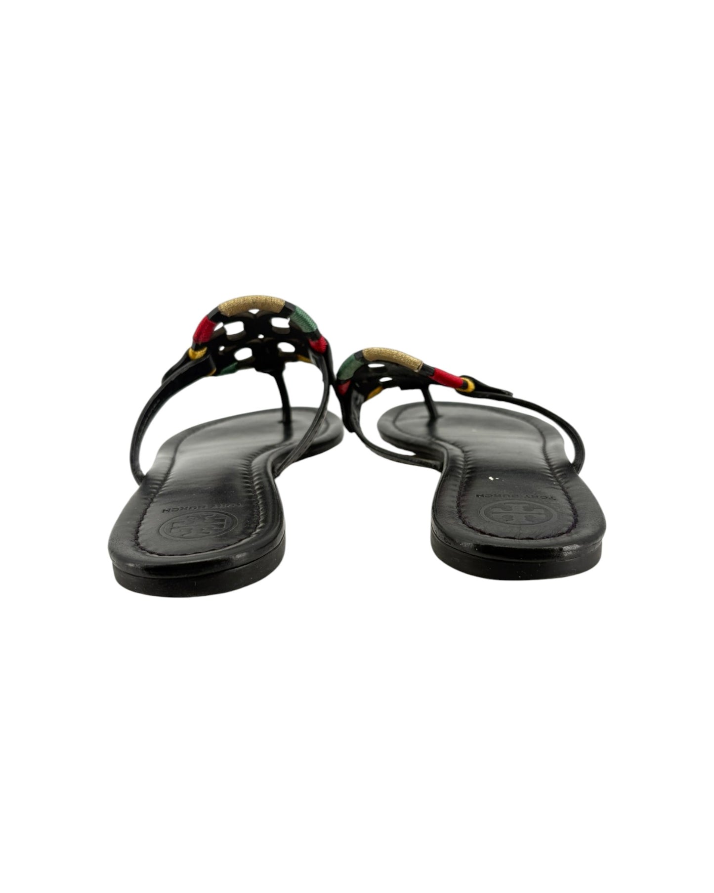 Black sandals with decorative straps on a white background
