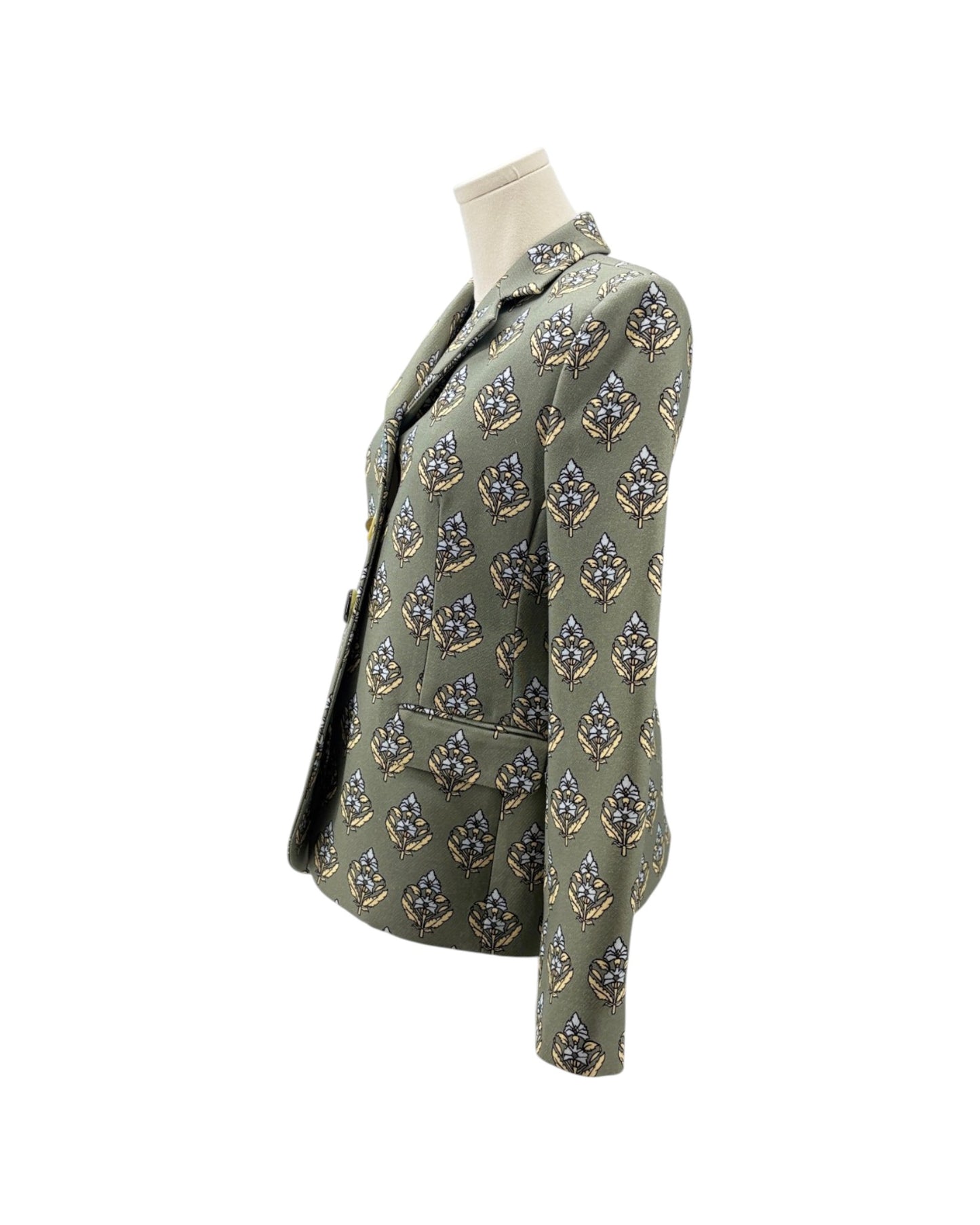 An olive green blazer jacket with a repeating geometric pattern in blue, gold, and white, displayed on a mannequin torso against a white background.