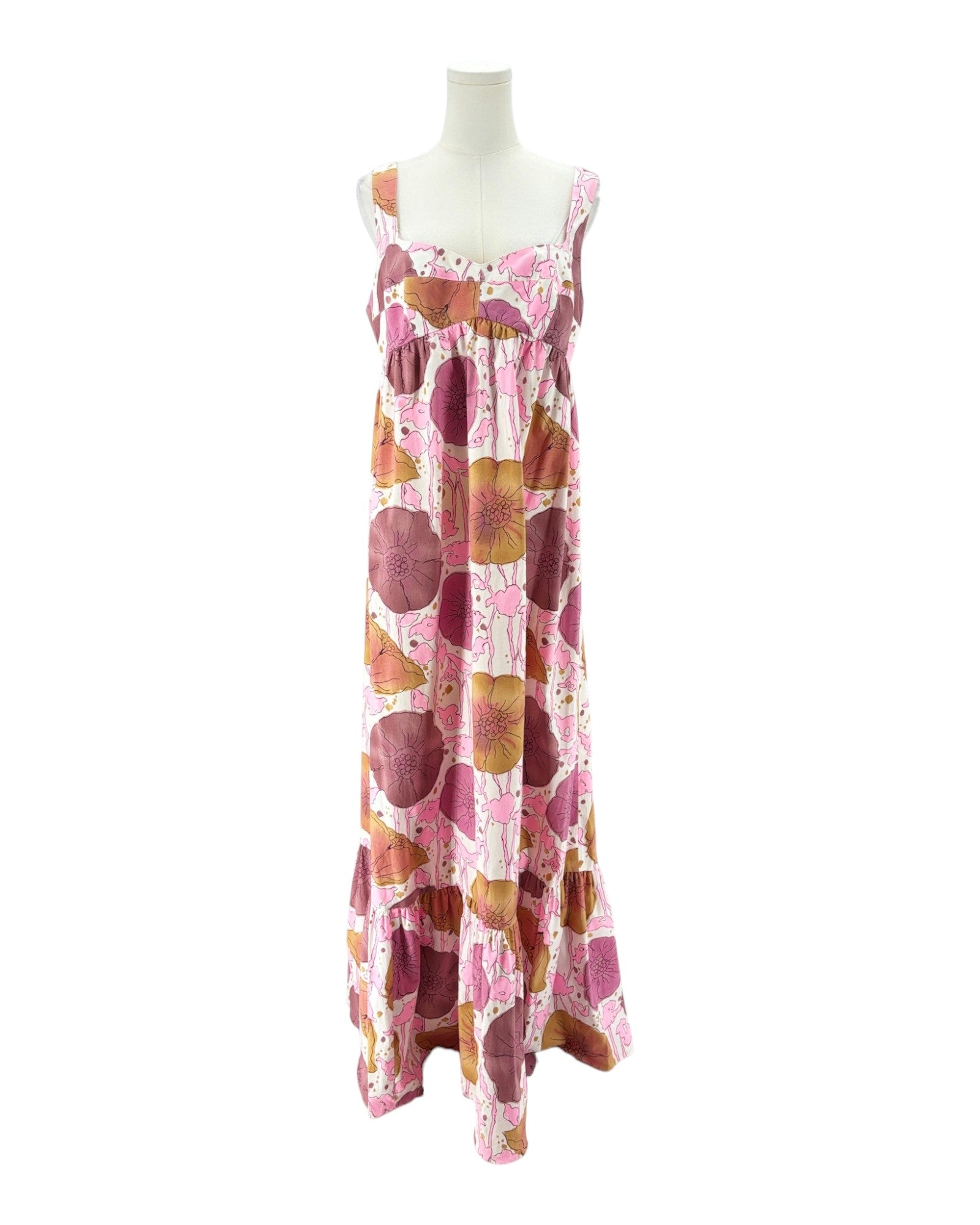 A sleeveless tiered maxi dress with a pink, brown, and orange abstract circle pattern, displayed on a white mannequin torso against a white background.