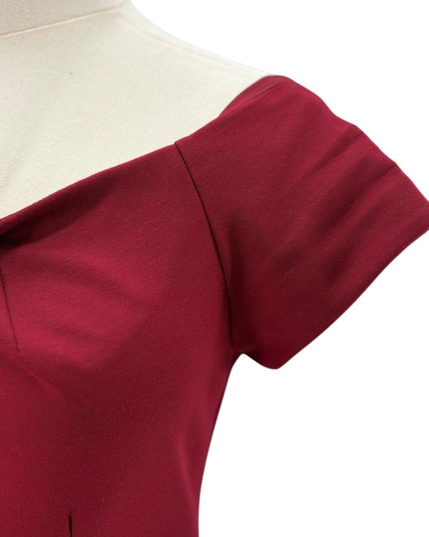 Trina Turk maroon red dress on a mannequin against a white background