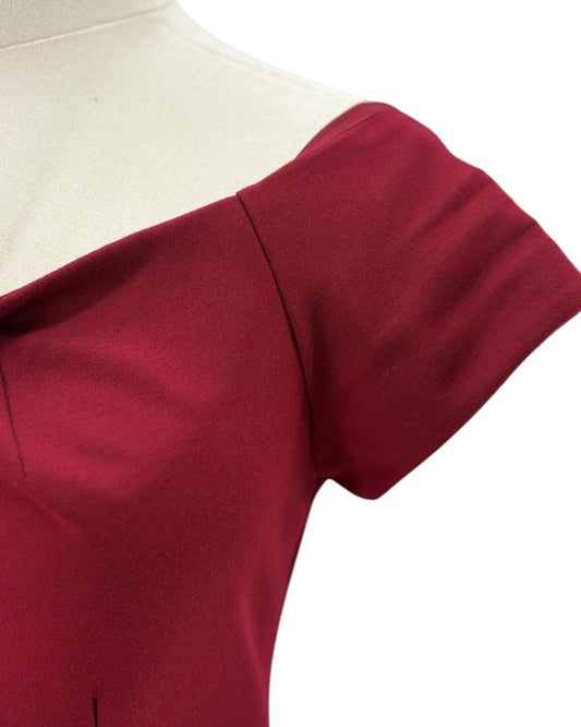 Trina Turk maroon red dress on a mannequin against a white background