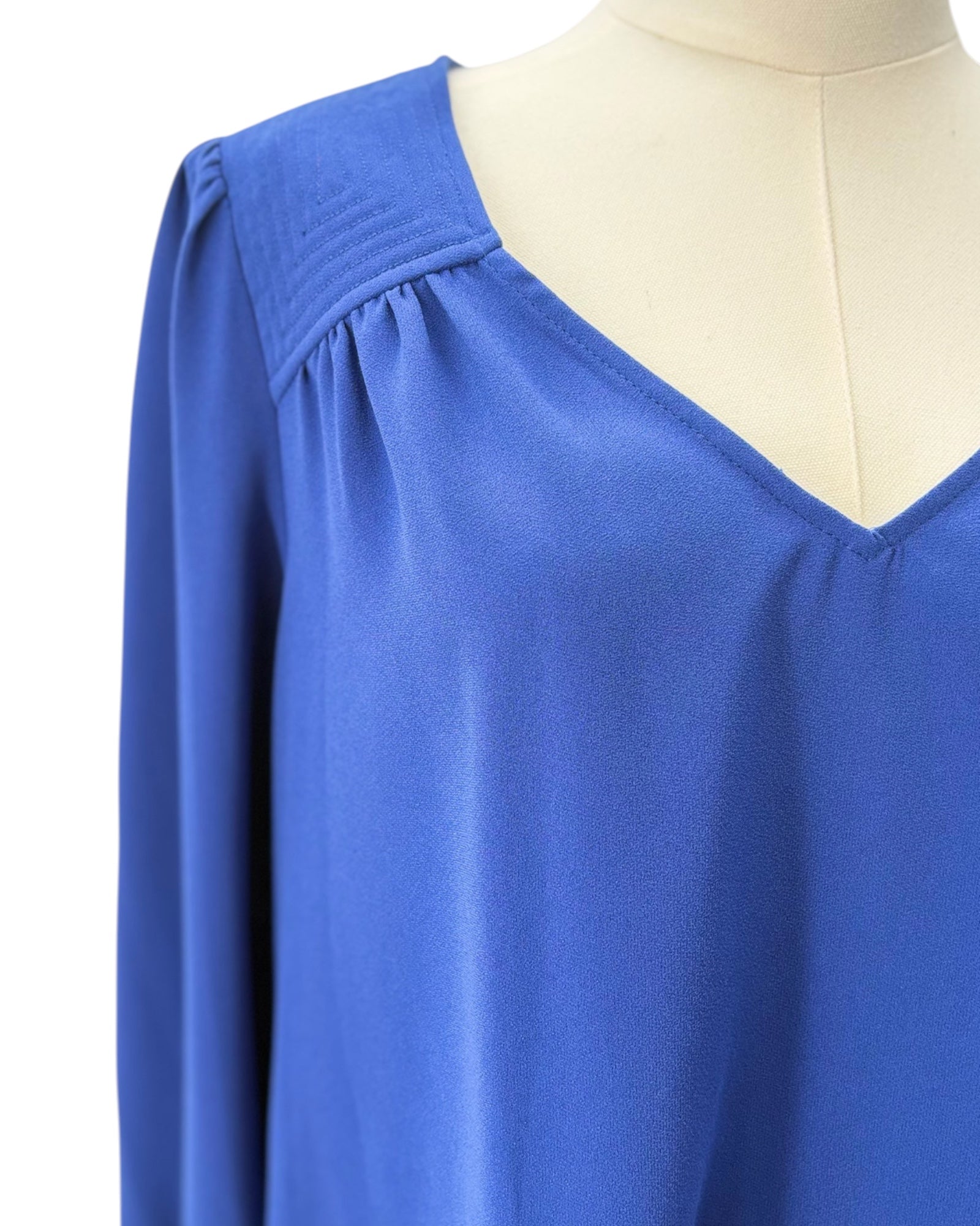 Blue blouse on a mannequin with a white background