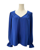 Blue blouse on a mannequin against a white background