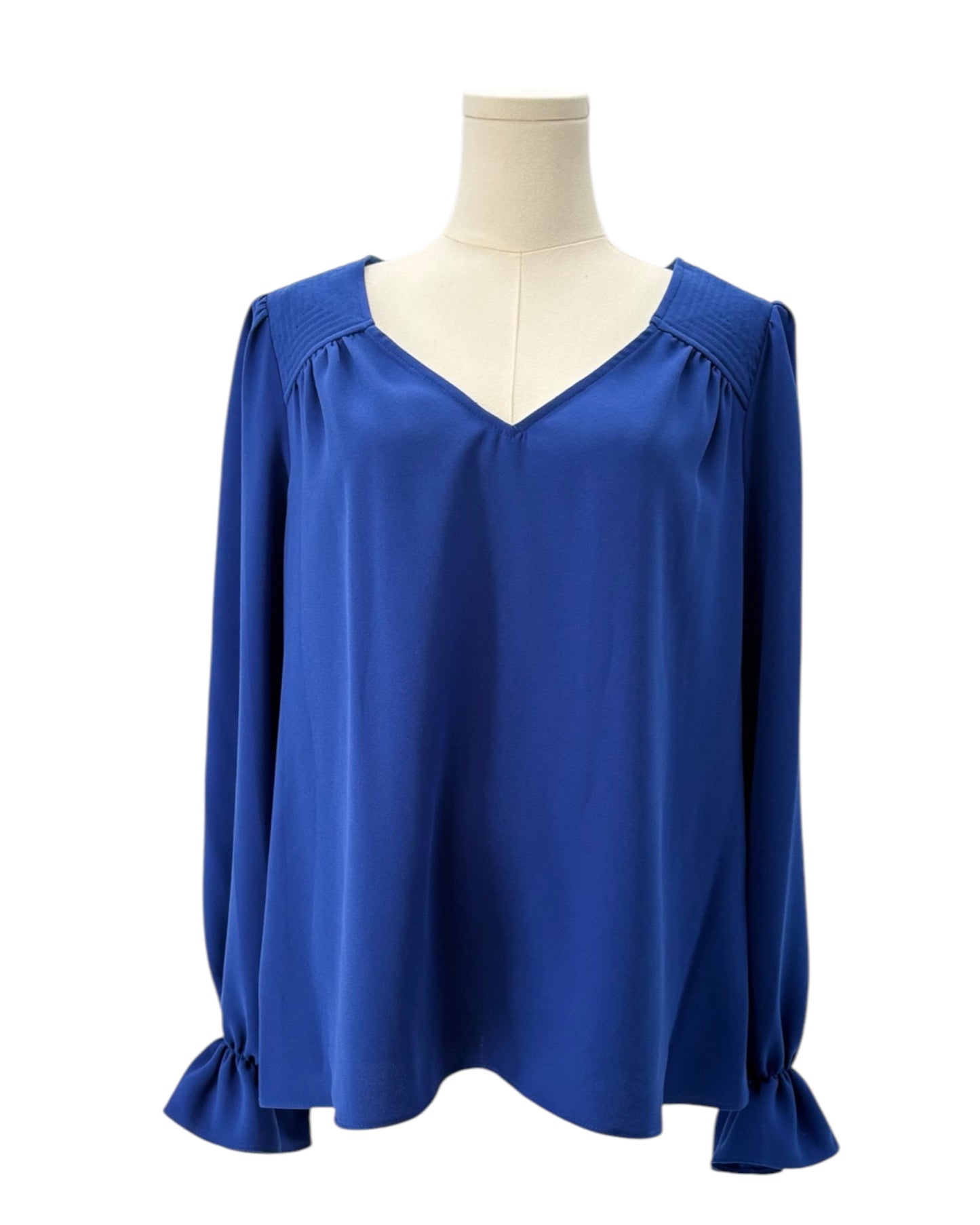 Blue blouse on a mannequin against a white background