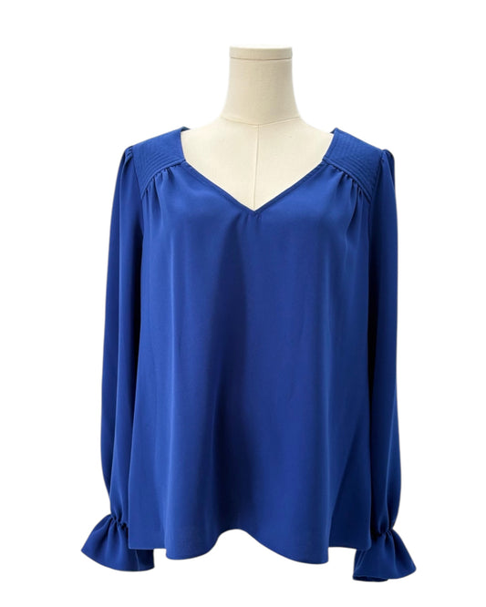 Blue blouse on a mannequin against a white background