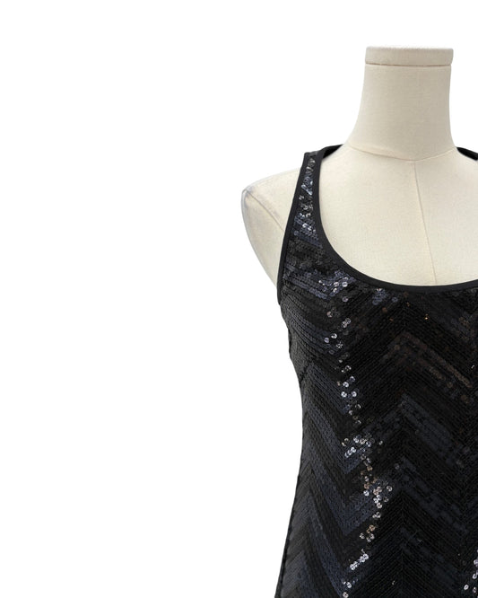 Black sequin dress on a mannequin against a white background