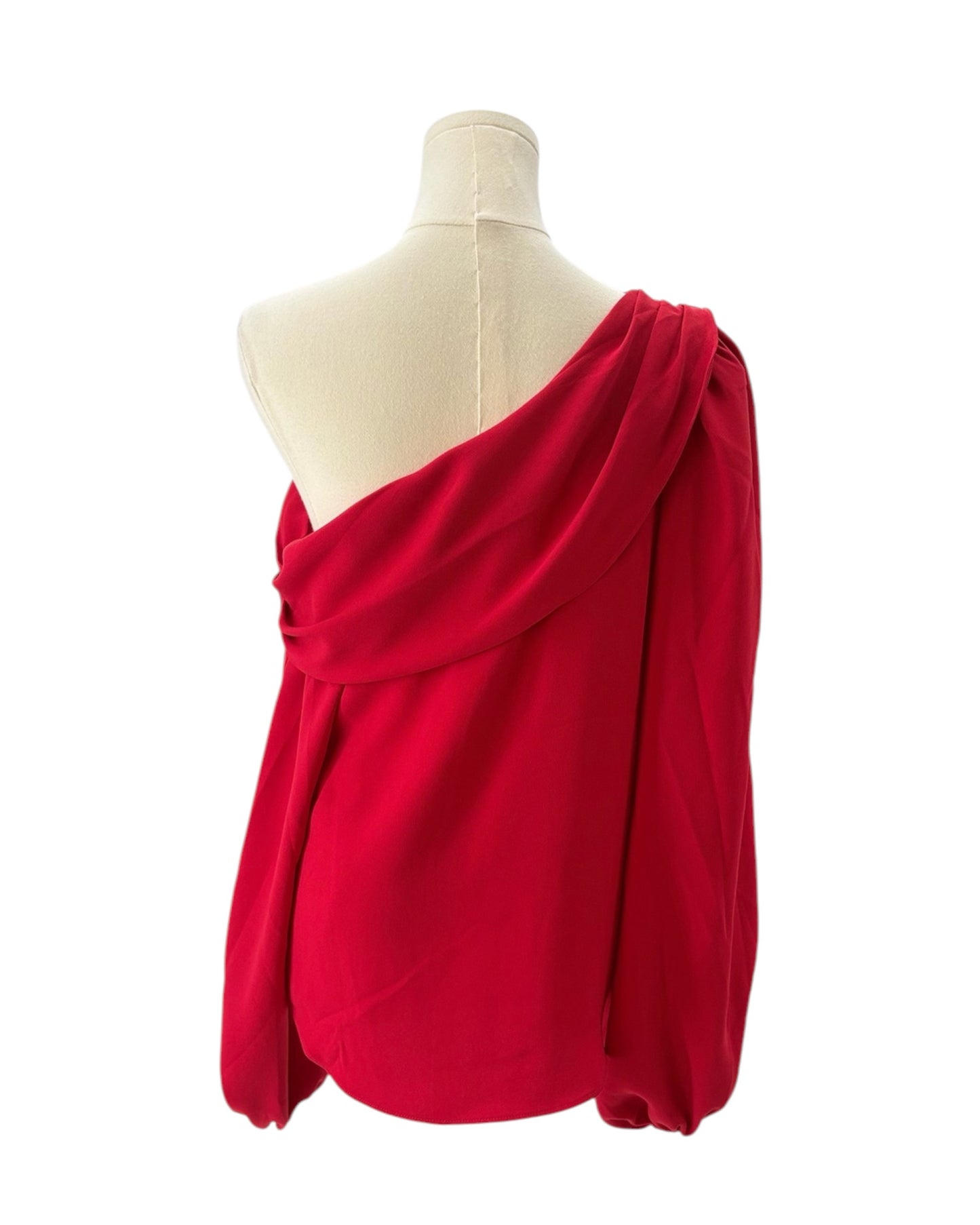 Red one-shoulder top on a mannequin against a white background