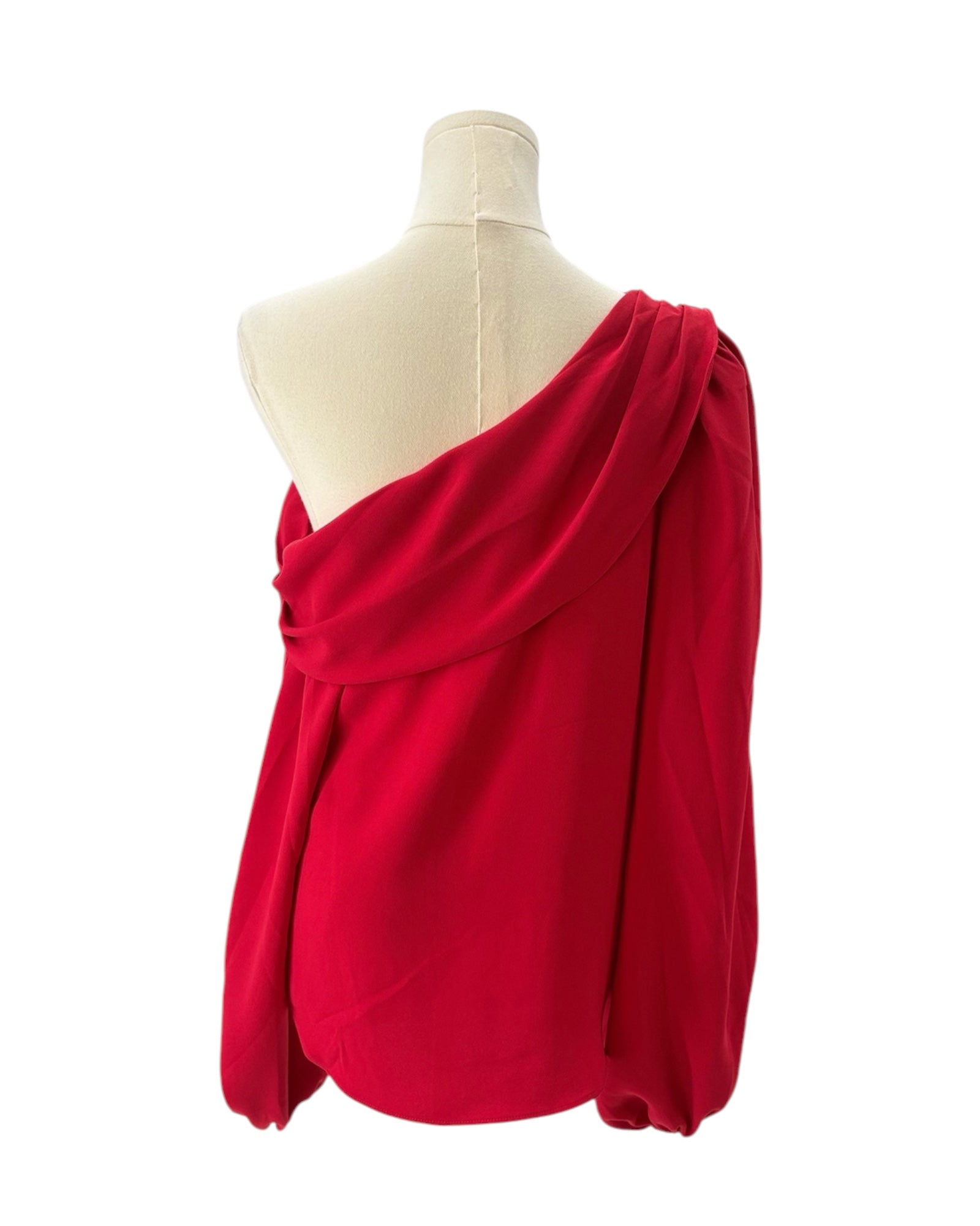 Red one-shoulder top on a mannequin against a white background