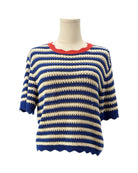 Blue and white striped sweater on a mannequin with a red trim against a white background