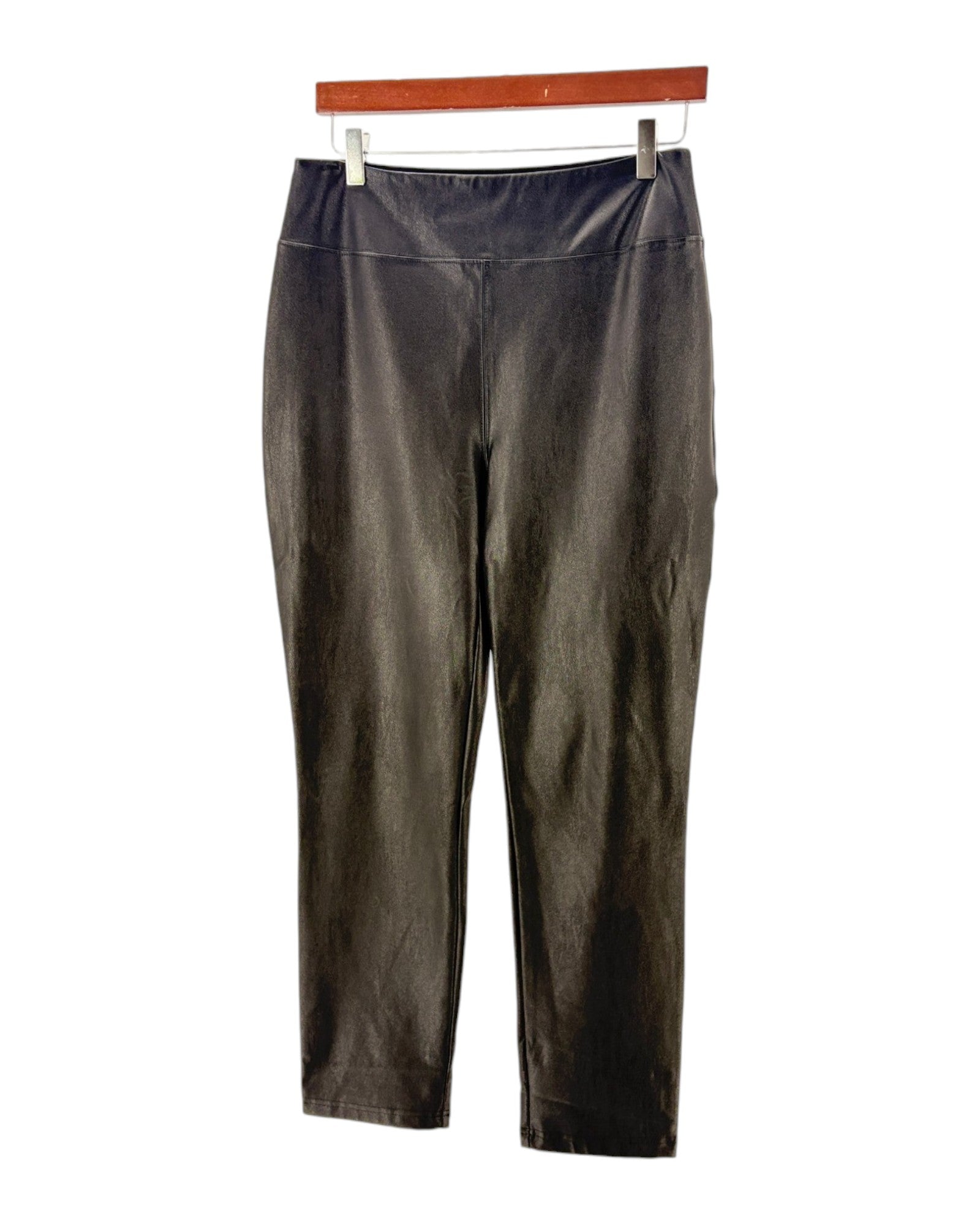 Black pants on a hanger against a white background
