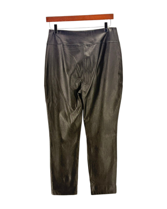 Black leather pants on a hanger against a white background