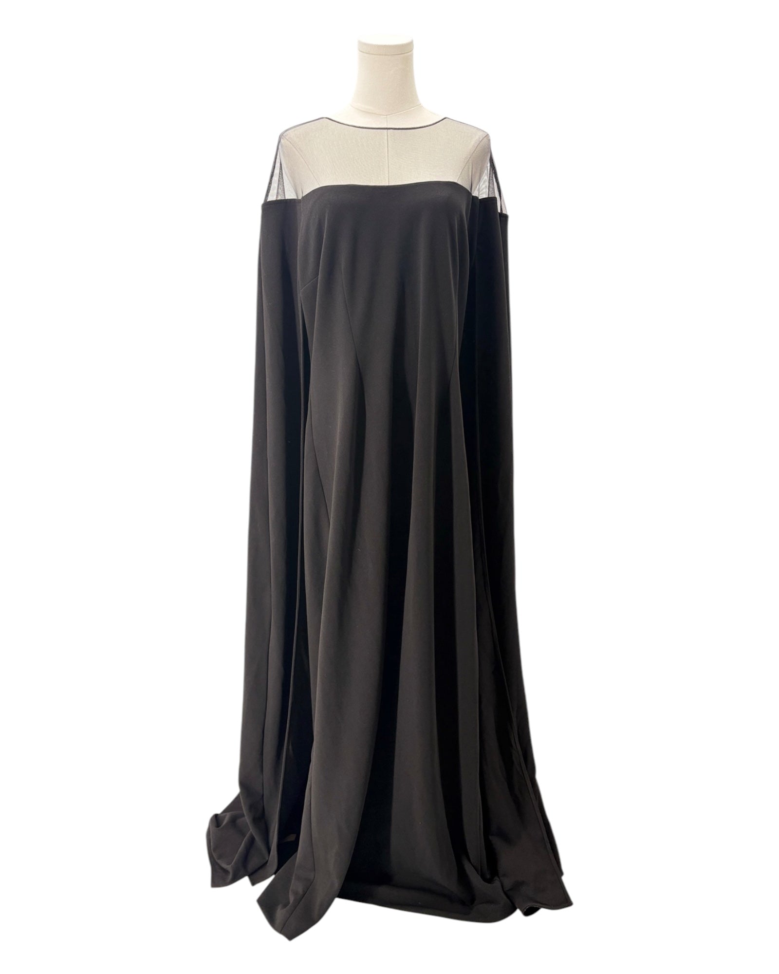 Black evening gown with sheer neckline on a mannequin against a white background