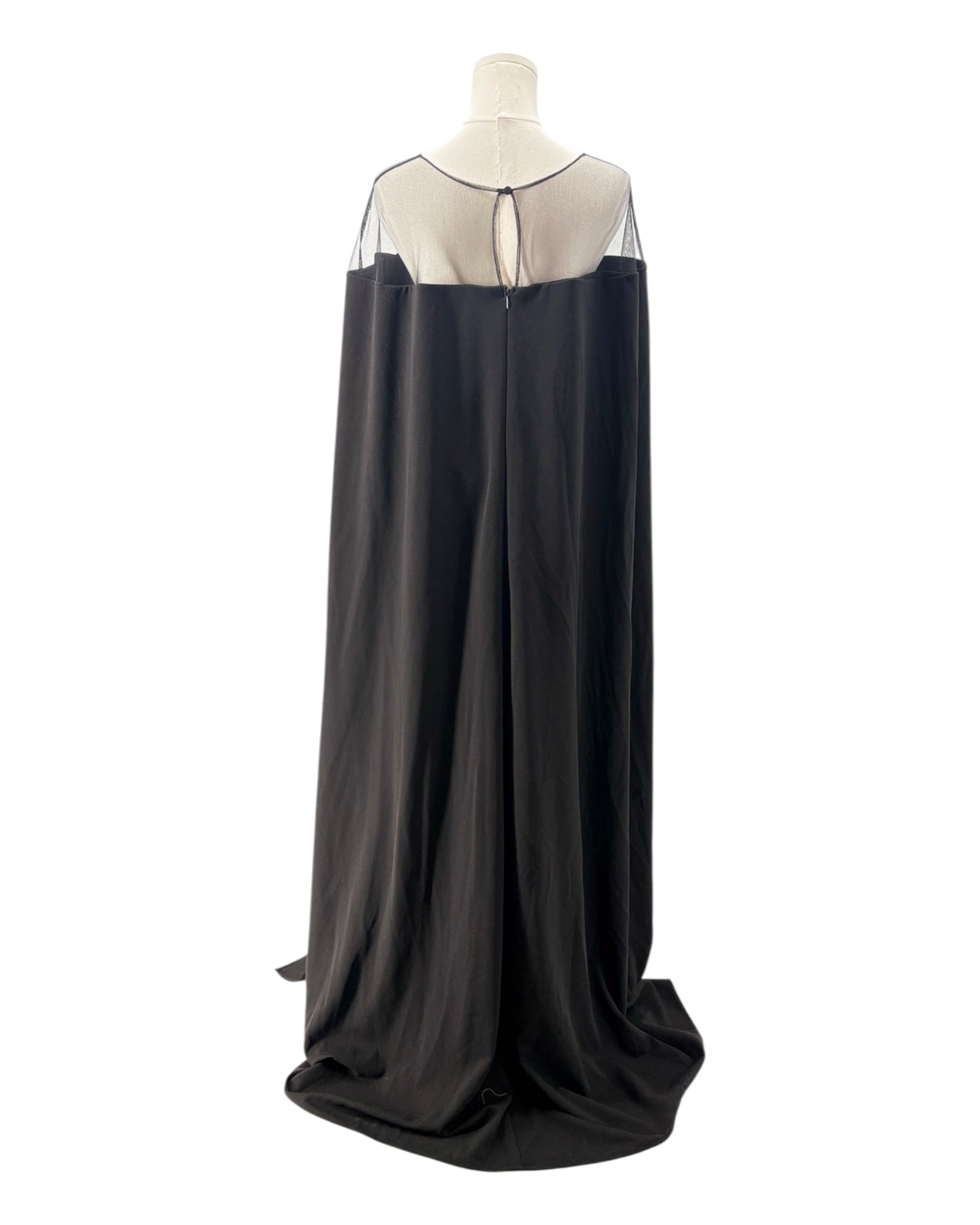 Black evening gown with sheer neckline on a mannequin against a white background