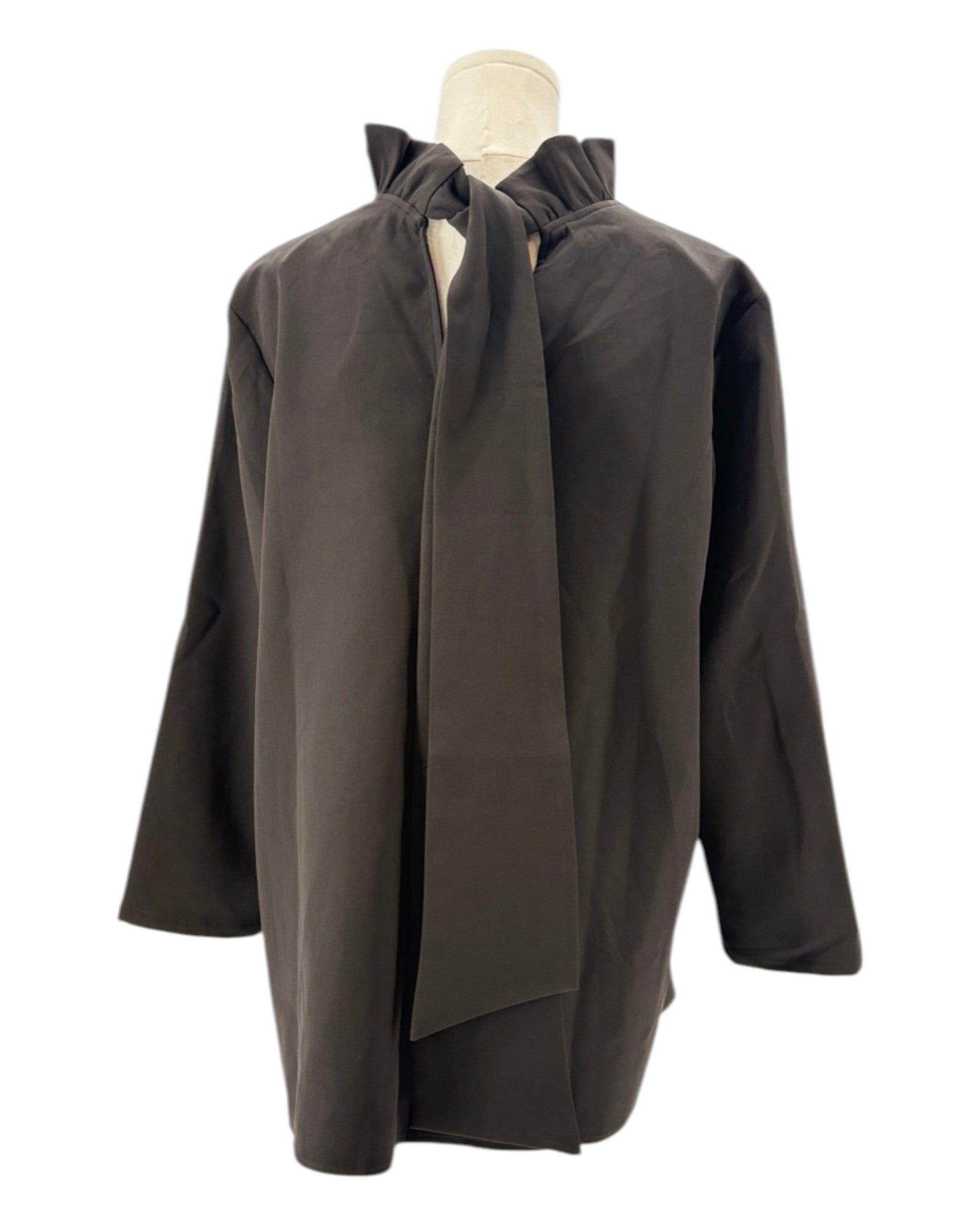 Tuckernuck black blouse with ruffle collar and a bow neckline on a mannequin against a white background
