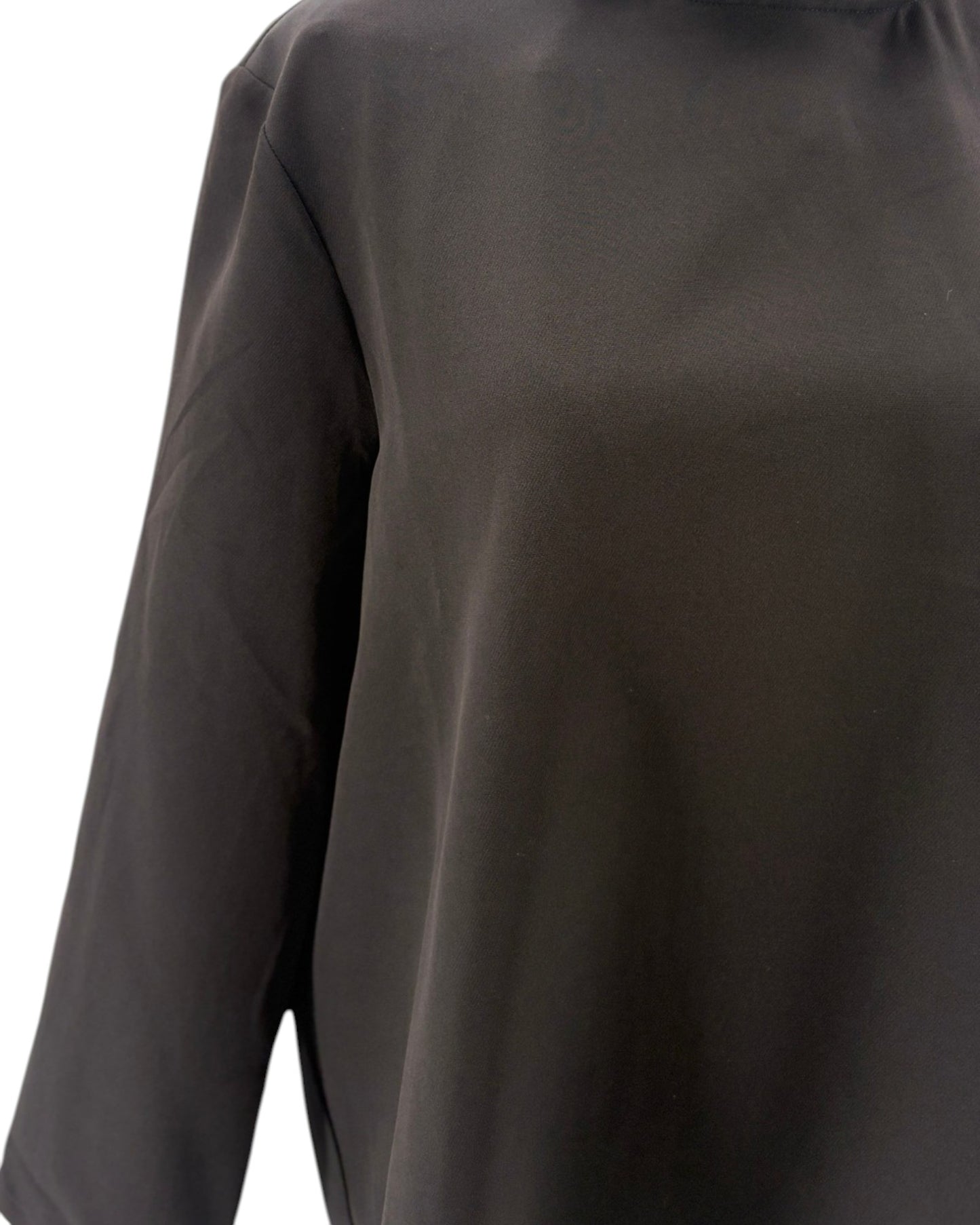 Tuckernuck black blouse with ruffle collar and a bow neckline on a mannequin against a white background