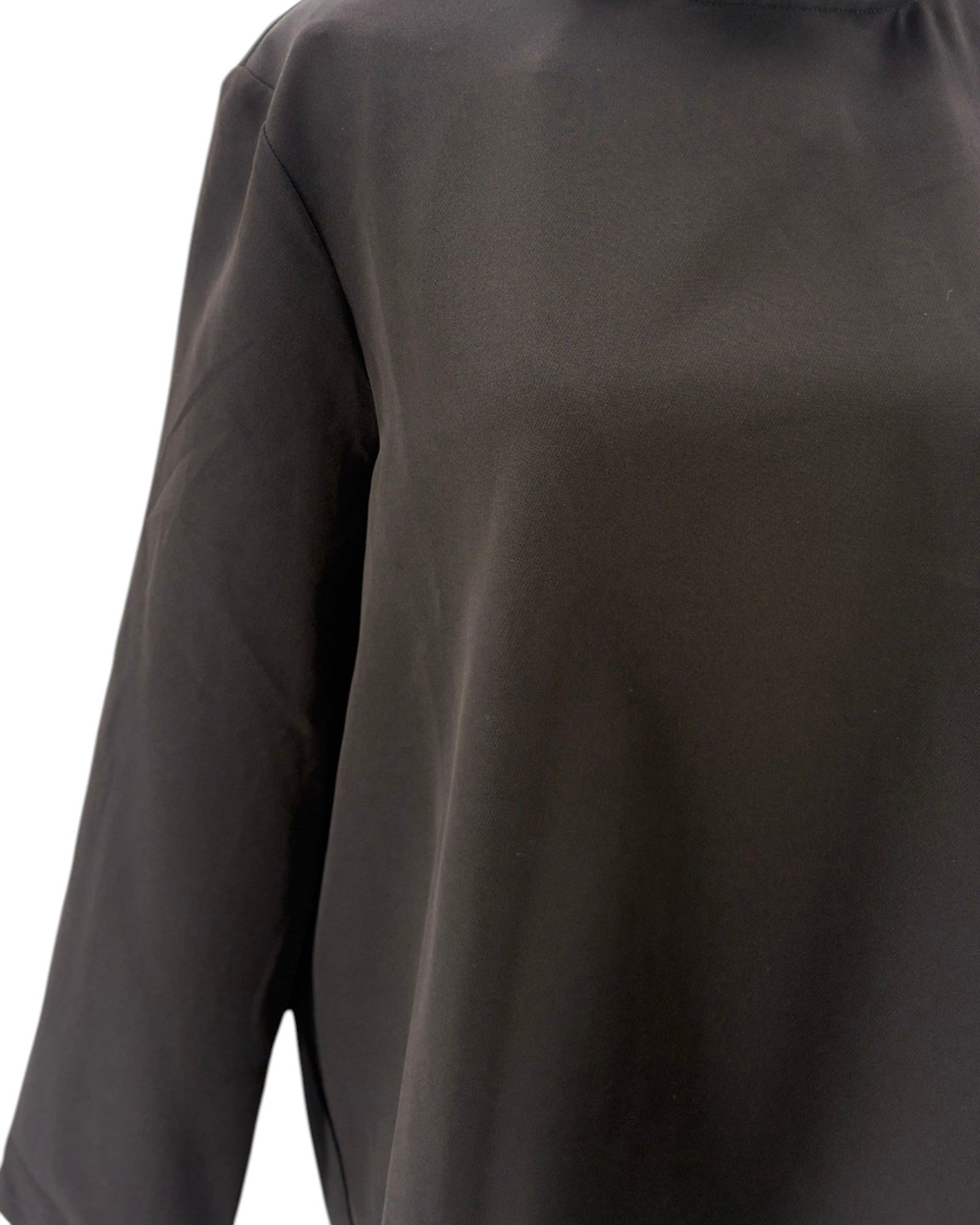 Tuckernuck black blouse with ruffle collar and a bow neckline on a mannequin against a white background