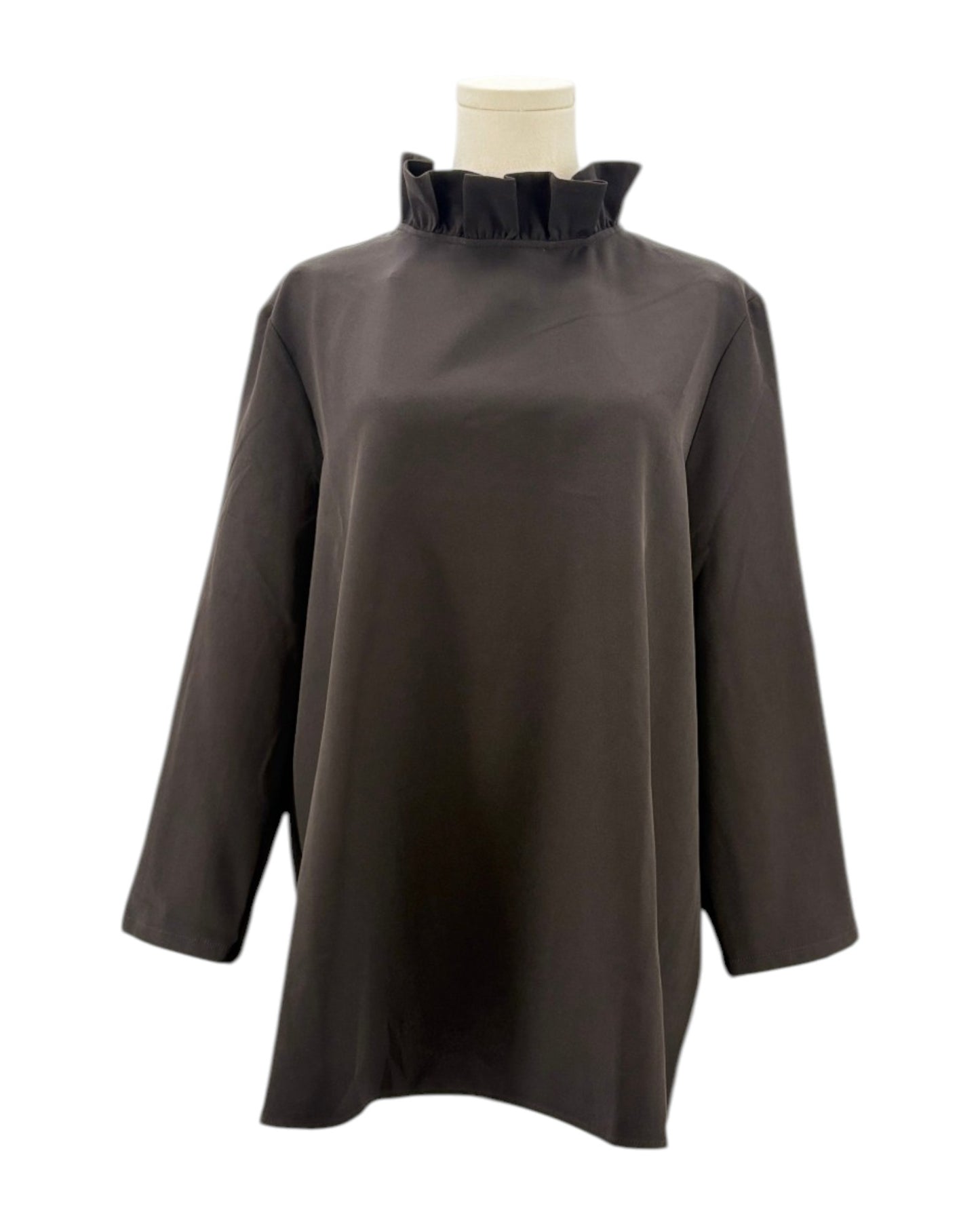 Tuckernuck black blouse with ruffle collar and a bow neckline on a mannequin against a white background