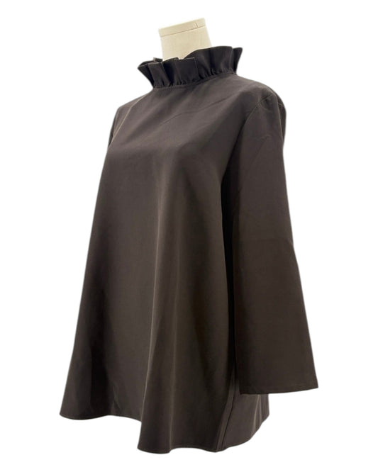 Tuckernuck black blouse with ruffle collar and a bow neckline on a mannequin against a white background