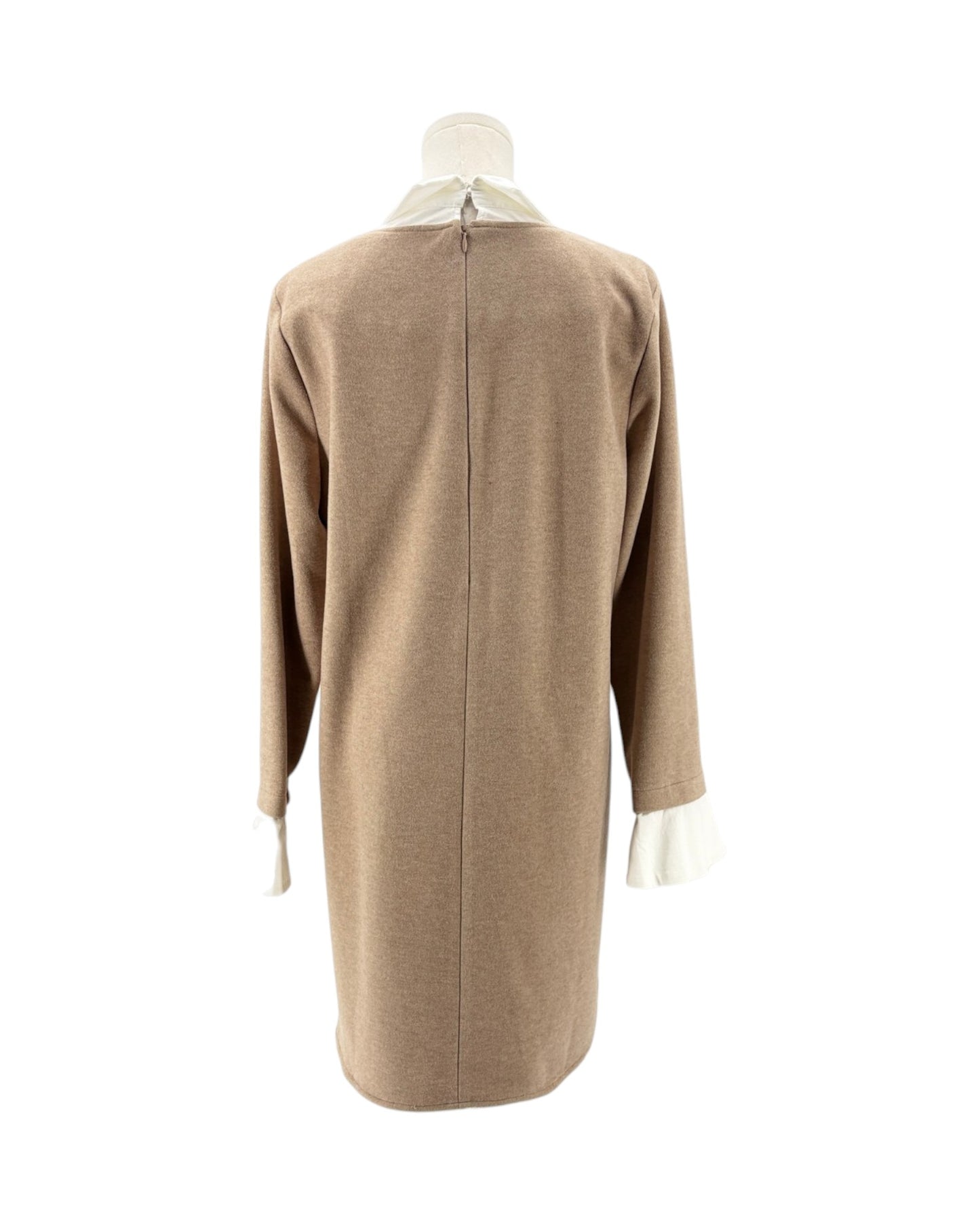 A beige knit long-sleeve dress shown from the back on a mannequin, featuring a white collar and white cuffs.